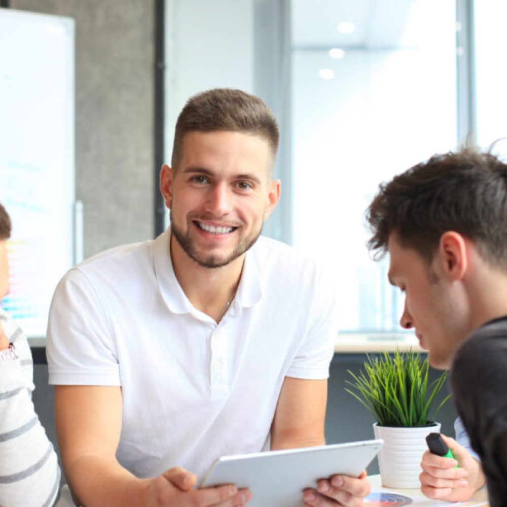 Group of young designers making sketches in office